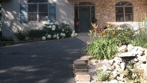 A two-story house with a stone facade and a front porch.