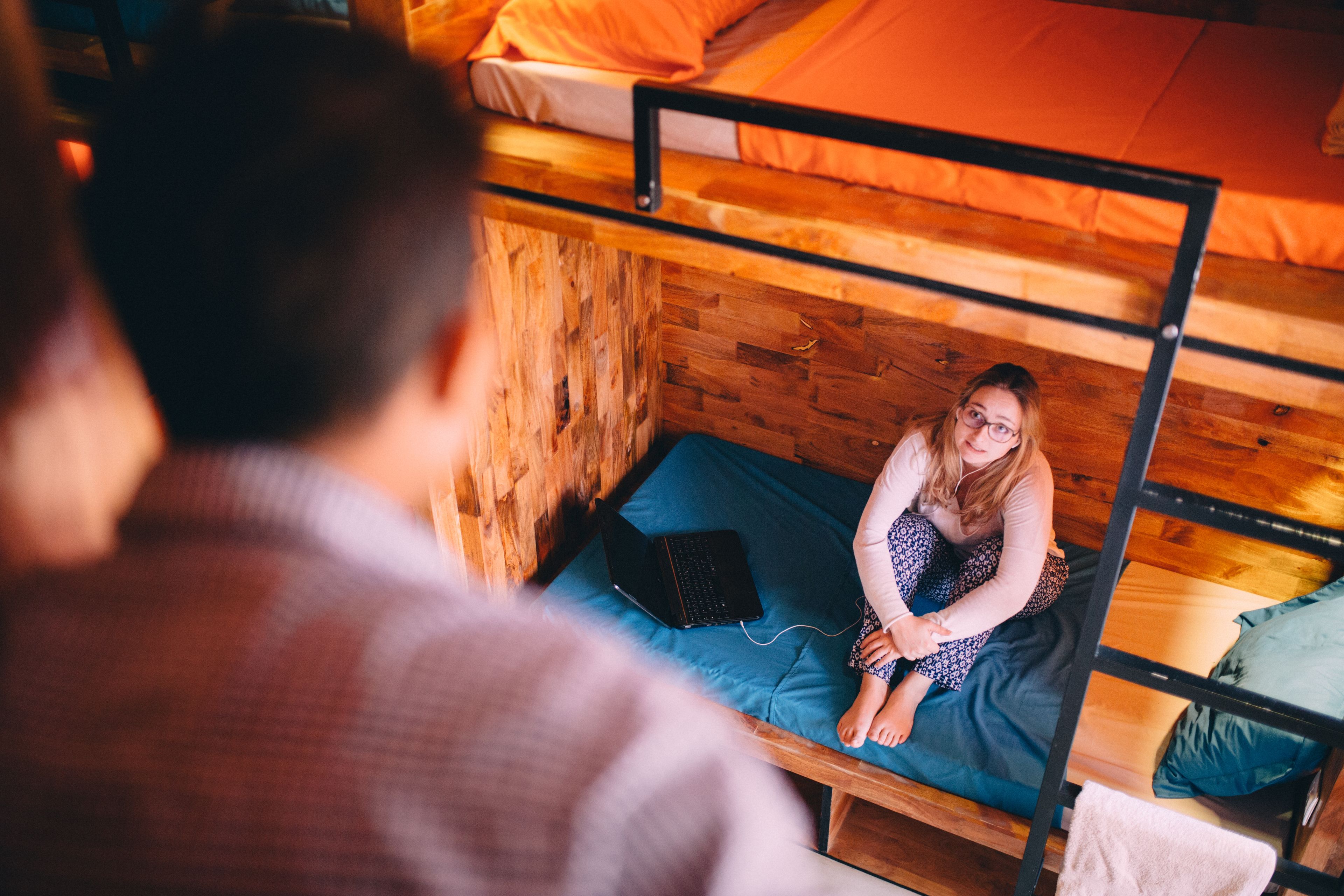 A bunk bed with a laptop on the lower bunk.