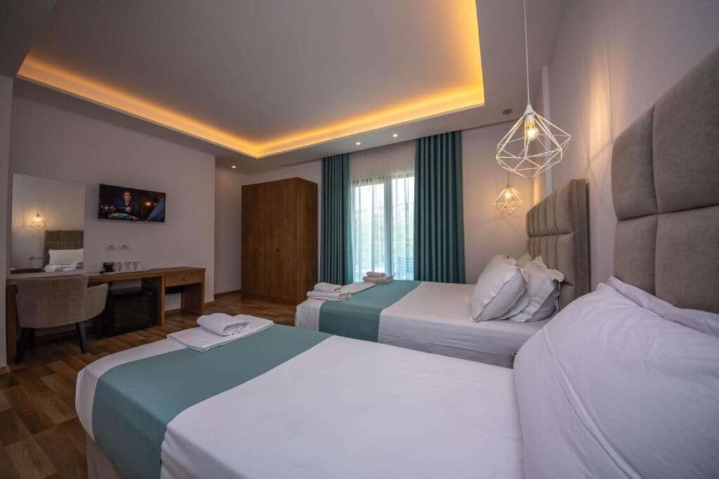 Deluxe Triple Room, Balcony | Minibar, in-room safe, desk, blackout drapes