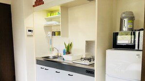 A compact kitchen with a built-in dishwasher, a gas stove, and a refrigerator.