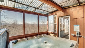 A hot tub with a view of mountains through large windows. - Pool, Hot Tub & Mountain Views: Cleveland Cabin (Cleveland)