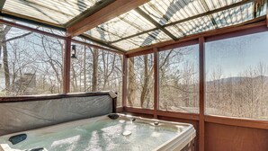A hot tub with a glass enclosure, wooden deck, and a view of trees and mountains. - Pool, Hot Tub & Mountain Views: Cleveland Cabin (Cleveland)