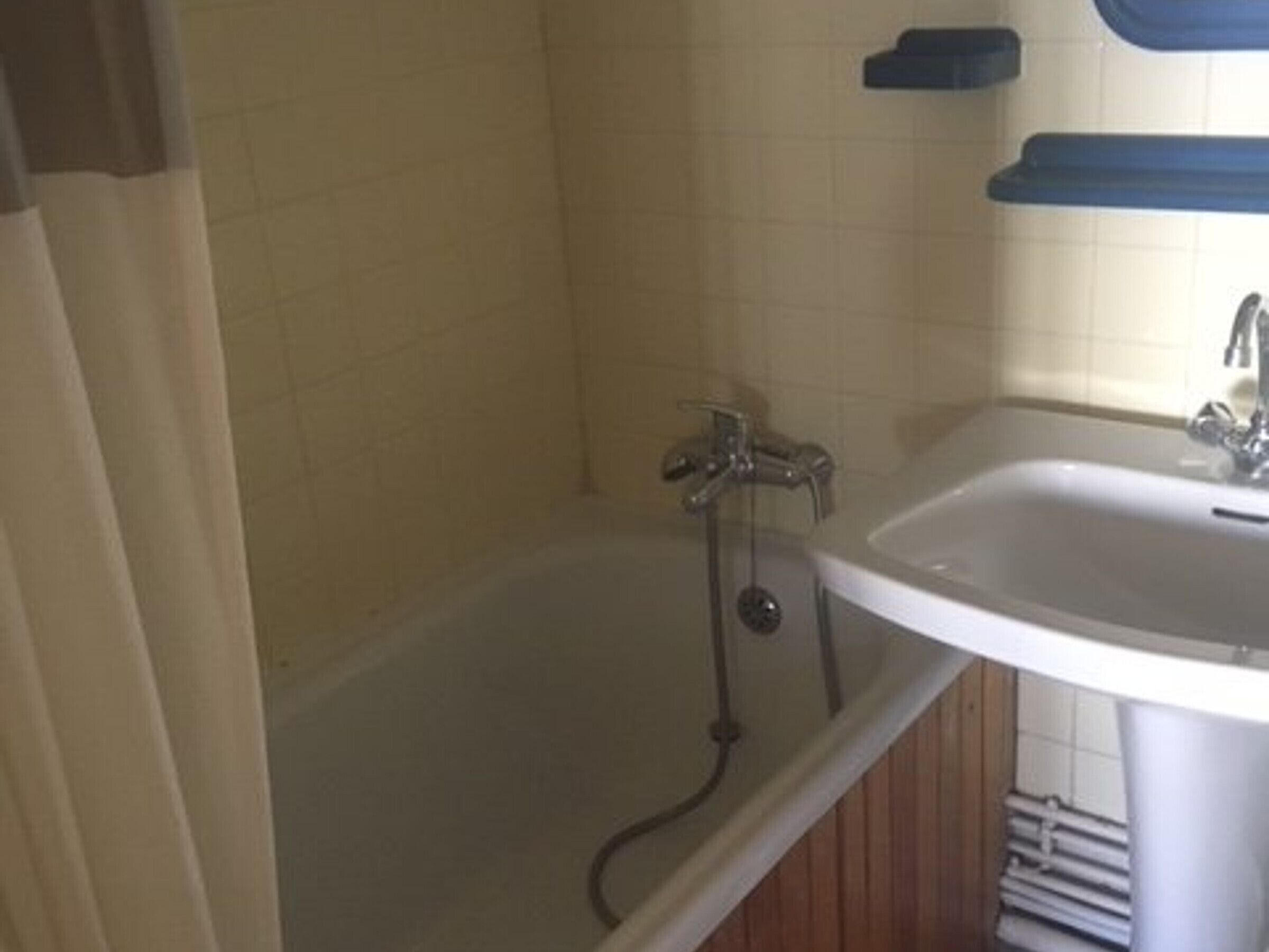 A bathroom with a bathtub, a sink, and a shower.