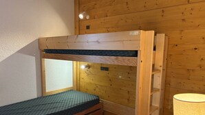A bunk bed with a window and a lamp.