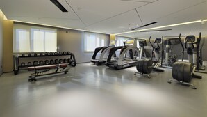 A modern gym with treadmills, weight machines, and a bench. - Mercure Taiyuan Changfeng Street (Taiyuan)