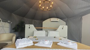 A cozy, tent-like room with a bed, bedside tables, and a chandelier. - Le Resort and Villas (Rawai)