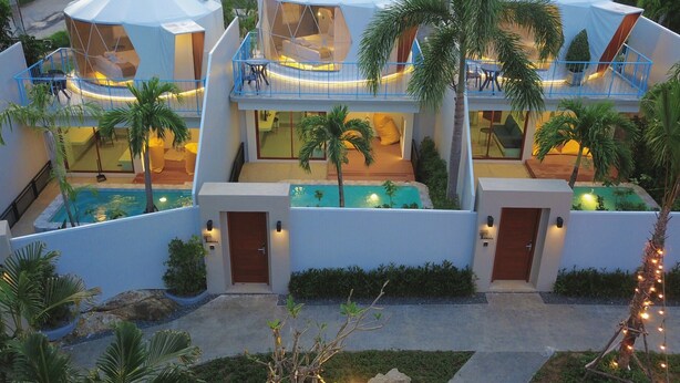 A modern resort with multiple hexagonal tents, a swimming pool, and lush landscaping. - Le Resort and Villas (Rawai)