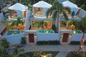 A modern resort with multiple hexagonal tents, a swimming pool, and lush landscaping. - Le Resort and Villas (Rawai)