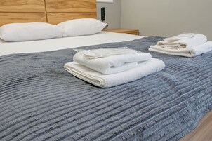 Premium bedding, pillow-top beds, laptop workspace, blackout curtains