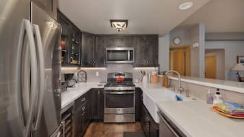 A modern kitchen with stainless steel appliances, a microwave, and a stove.