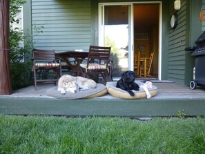 A porch with two dog beds, a wooden table, and chairs. - Snowcreek V 2 Bedroom 2 Bath Cozy 5 ⭐️ Mountain Retreat! (Mammoth Lakes)
