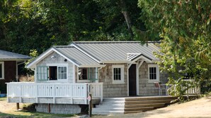 A small wooden cabin with a porch and steps leading to the entrance. - Hood Canal, 1930's Beach Cottage,  315' Cove with Oysters! (Hoodsport)