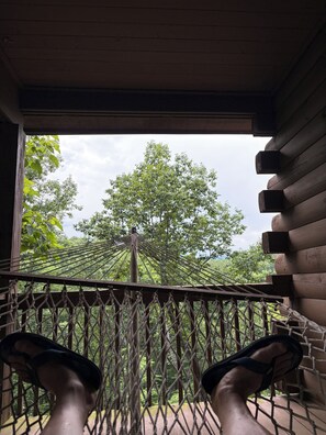A hammock with a view of a tree and a wooden structure. - Private Cabin with Views, Fenced Yard, Gameroom, Gas Fireplace, Central Location (Lake Lure)