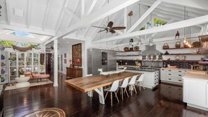 A spacious kitchen with a large island, white cabinetry, and modern appliances. - Blu on White- 4BR Old Town Key West Home with Heated Pool (Key West)