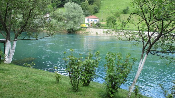 A house by a river with a grassy bank and trees. - Peaceful Oasis - House For Rest And Relaxation (Bosanska Krupa)