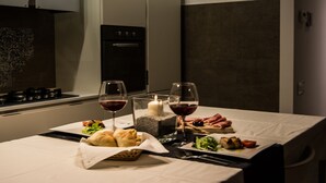 A dining table set with food and wine glasses, a candle, and a decorative centerpiece. - Ideal starting point to experience Palermo and its many facets! (Palermo)