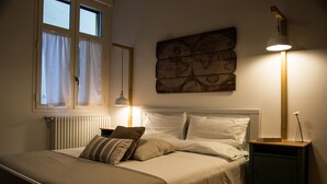 A bedroom with a bed, a nightstand, a lamp, a window with curtains, and a wall-mounted map. - Ideal starting point to experience Palermo and its many facets! (Palermo)