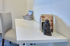 A white table with a book titled 'Charlie Wilson's War' and a figurine on it.