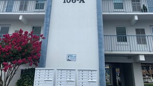 A building with a sign reading "The Quarters at Marlin Cove, 106-A".
