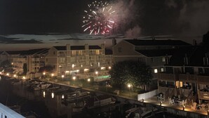 A residential area with houses, a dock, and a balcony overlooking the scene.