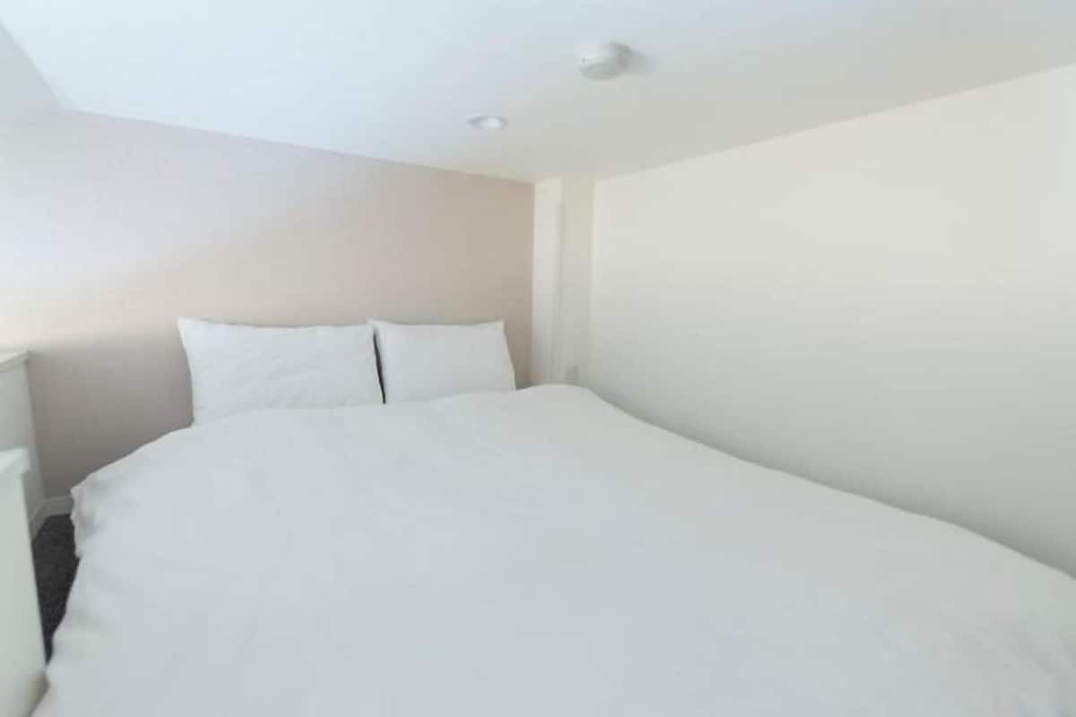 Escritorio, cortinas blackout y tabla de planchar con plancha