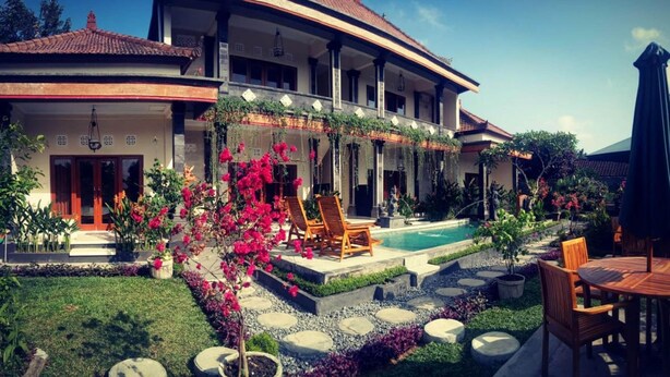 A large, two-story house with a swimming pool, outdoor seating, and a well-maintained garden. - Pondok Ayu Homestay (Ubud)