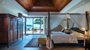 Um quarto espaçoso com cama de dossel, teto de madeira e vista para o exterior.