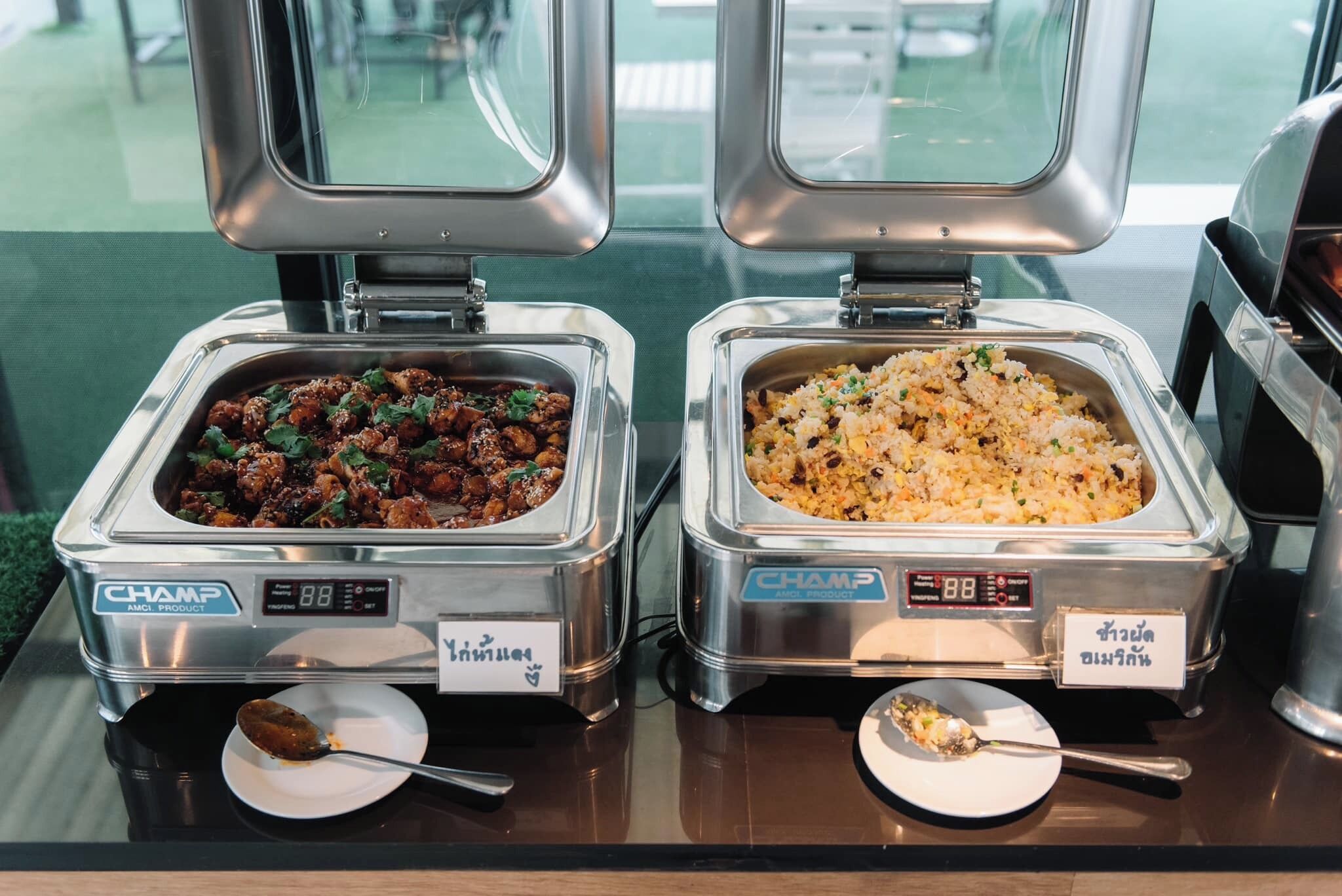Two buffet stations with food containers labeled 'CHAMP AMI PRODUCT' and 'CHAMP AMI PRODUCT'.