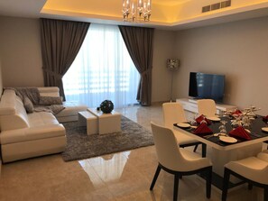 32-inch flat-screen TV with satellite channels, TV - Al Manzil Residence Hidd 2 (Hidd)