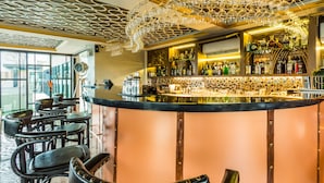A bar area with a curved counter, multiple seating options, and a decorative ceiling. - 6 Avenue Surin by Lofty (Choeng Thale)