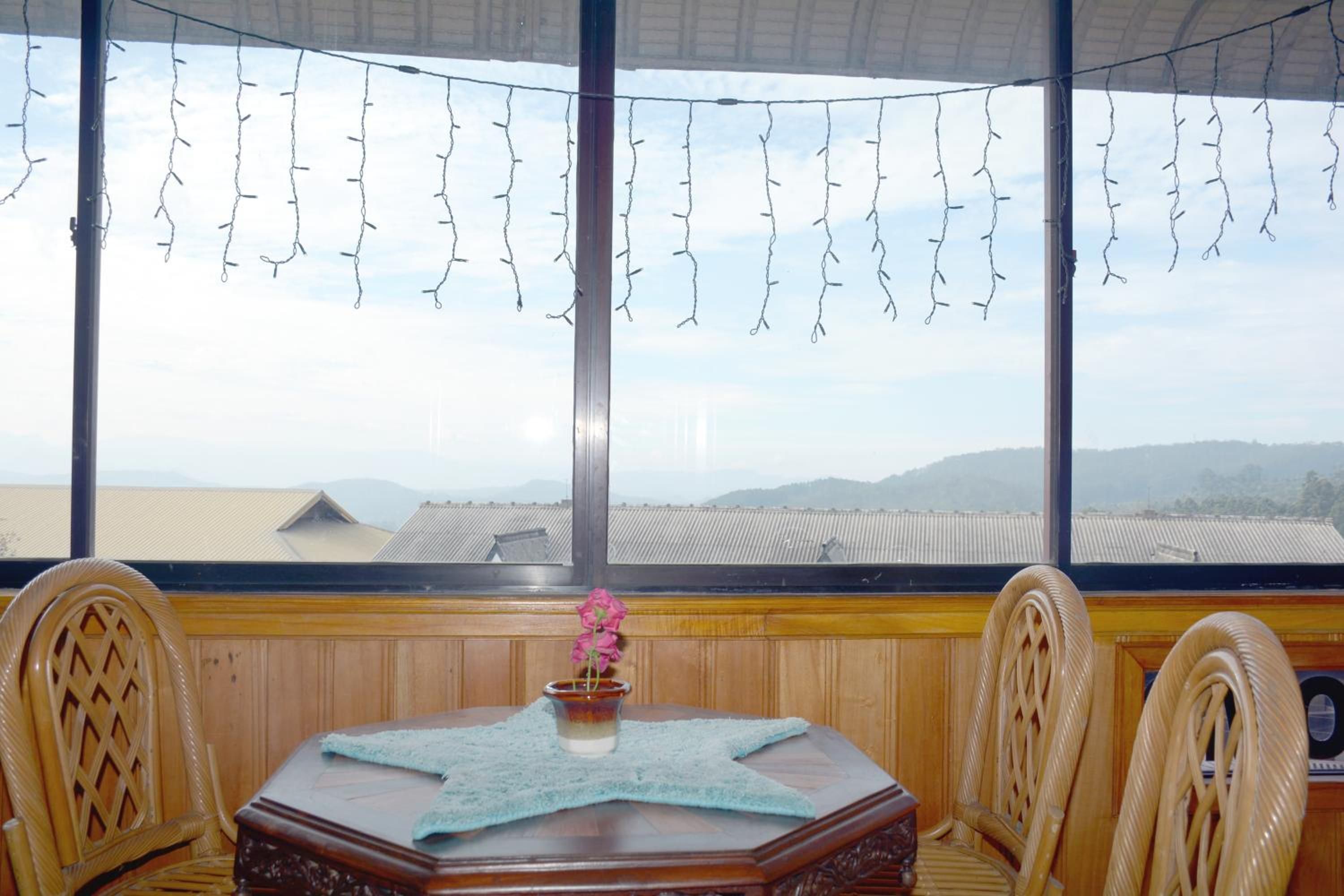 A room with a large window, a starfish-patterned table, and chairs.