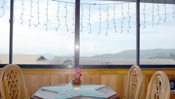 A room with a large window, a starfish-patterned table, and chairs.