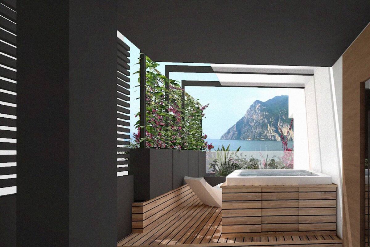 Un baño moderno con piso de madera, una bañera empotrada y vistas a un paisaje montañoso.