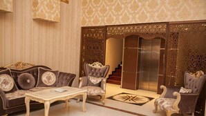 A luxurious lobby with a sofa set, armchairs, and a coffee table. - Golden Shine Hotel (Baku)