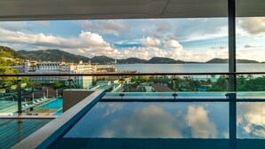 A pool area with a view of a cityscape and mountains. - Privilege Residences by Lofty (Patong)