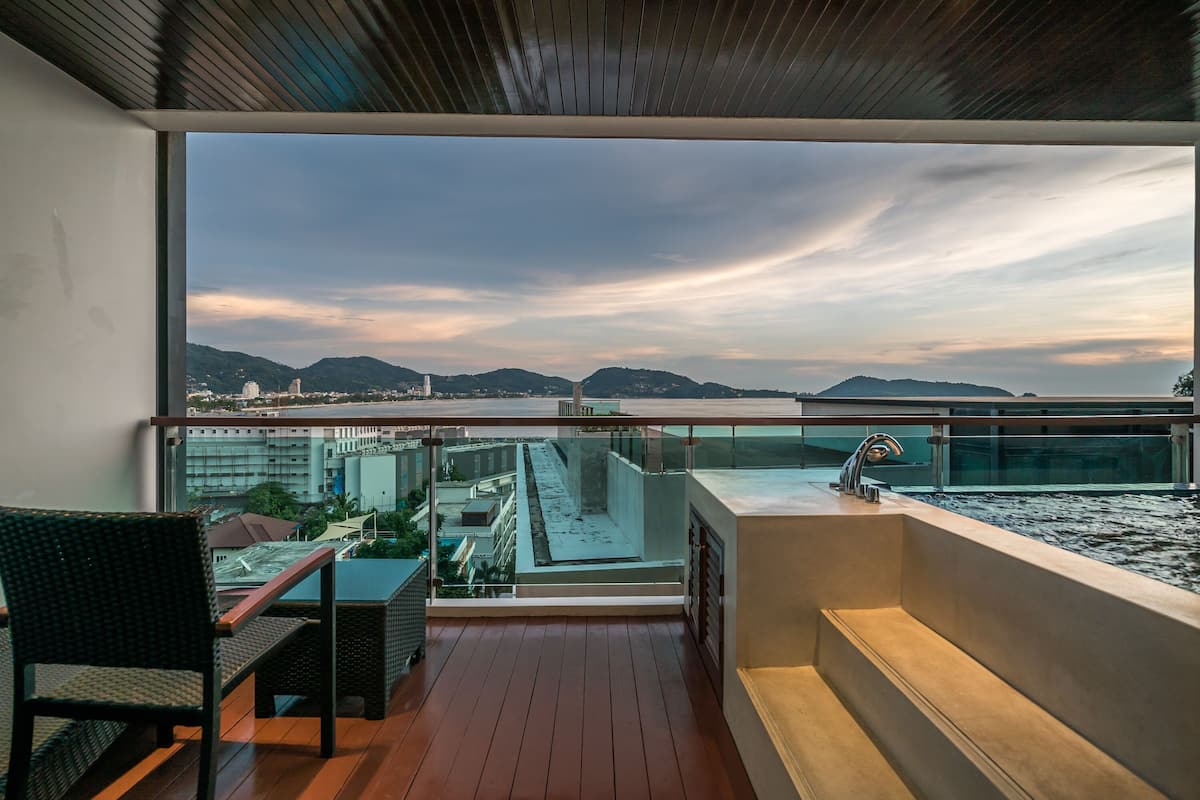 Un balcon donnant sur un paysage urbain, une table et une chaise.