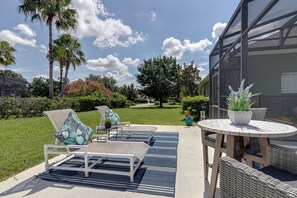 Relax in a serene outdoor space surrounded by lush greenery and a tranquil view.