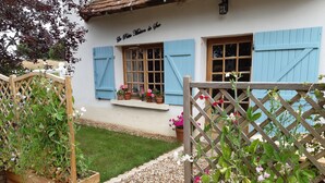 A white building with blue shutters and a sign reading "Le Petit Moulin de Poche". - Private pool in a beautiful, romantic retreat, offering peace and quiet (Noyant-Villages)