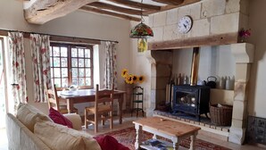 A cozy living room with a sofa, wooden table, and a fireplace. - Private pool in a beautiful, romantic retreat, offering peace and quiet (Noyant-Villages)