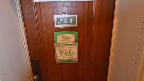 A wooden door with a nameplate reading "Vichy" and a "Slide to Open" sign. - Room Vichy (Roma)