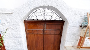 A wooden door with a metal architrave, leading to a stone staircase. - Villa Andreas (Hydra)