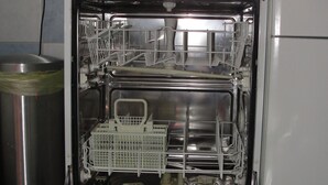 An open dishwasher with racks and utensils inside. - Family-friendly spacious and luxurious detached vacation home for 8 to 9 people (Lenterode)