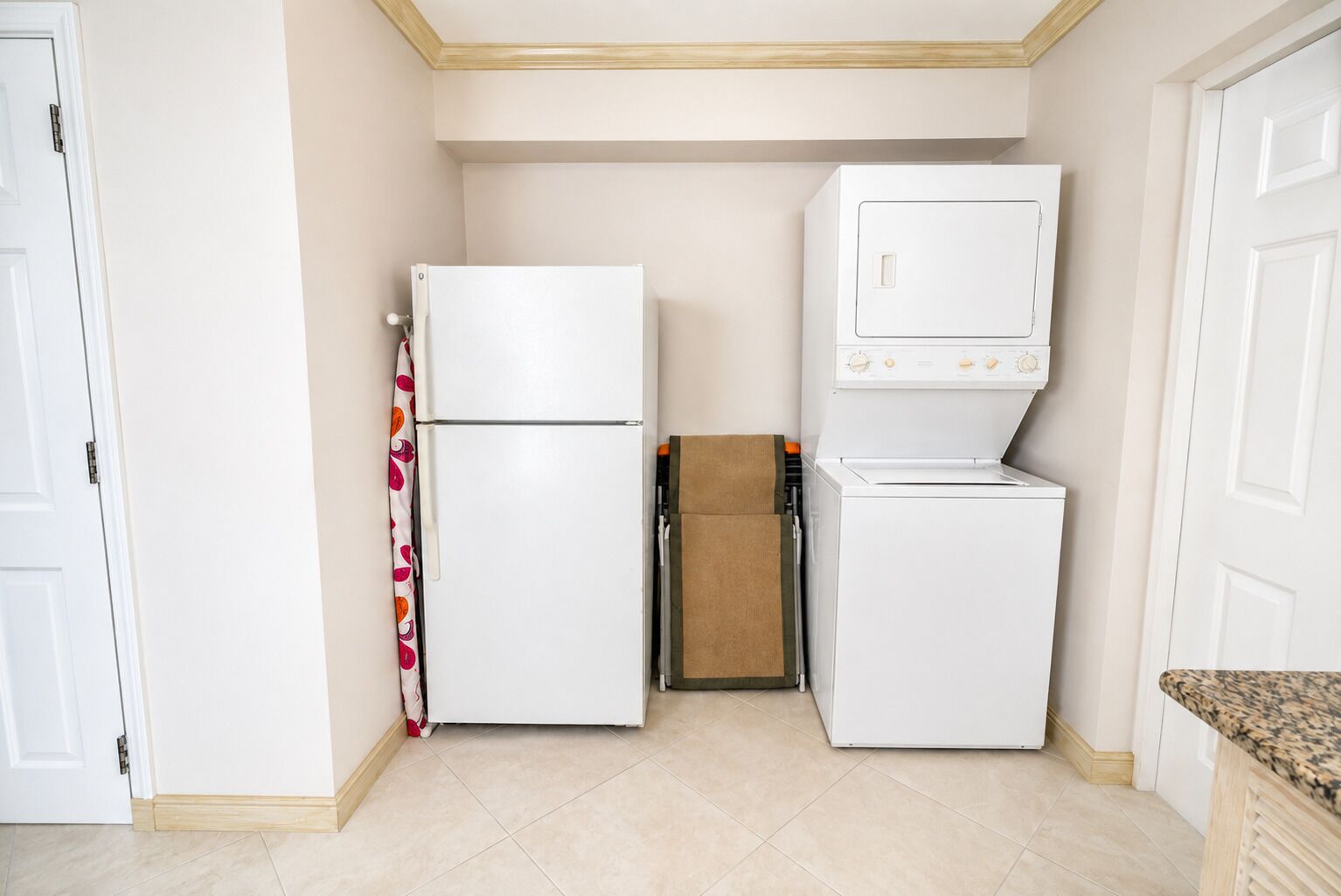 A compact kitchen with a refrigerator, microwave, and a small countertop.