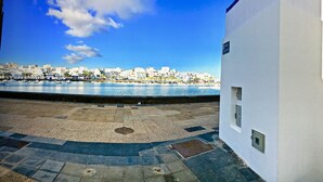 A coastal building with a view of a beach and boats, a narrow alleyway, and a stone wall. - 5 ***** Serena Studio with private chill out. (Arrecife)