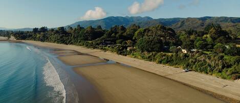 A coastal beach with a sandy shore and a clear blue sea.