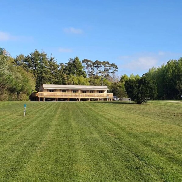A large, single-story building with a flat roof and a long, narrow structure. - Golden Bay Holiday Park (Parapara)