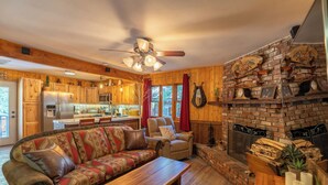 A cozy living room with a sofa, a coffee table, and a fireplace.