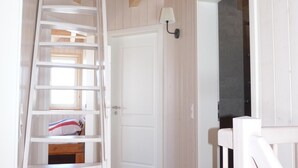 A wooden staircase leading to a bedroom with a bed and a nightstand. - Biological holiday above the clouds of Carinthia in every season (Hochrindl-Kegel)