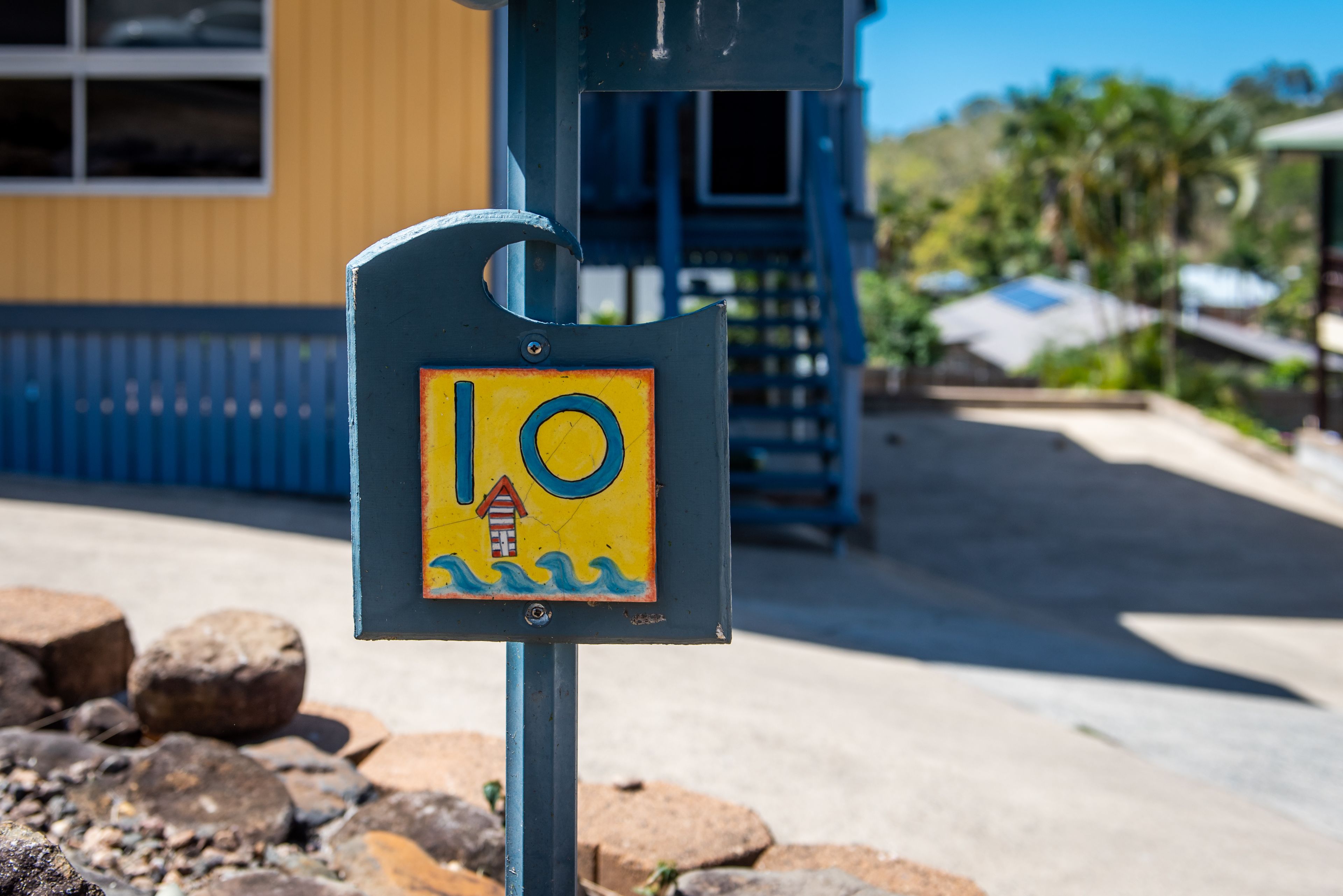 A sign with a lifeguard symbol and the number 10, indicating a lifeguard station.