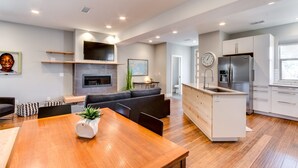 A modern kitchen with a built-in oven, a refrigerator, and a sink. - Downtown Views and Brews (Fort Collins)